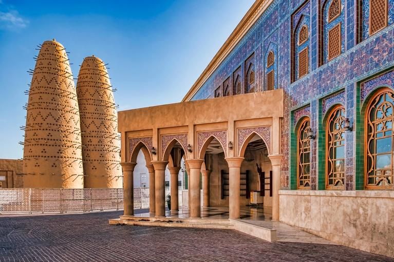 View of Blue Tiled Mosque with Traditional Islamic Architecture and Dual Pigeon Towers in Katara Cultural Village, Doha, Qatar